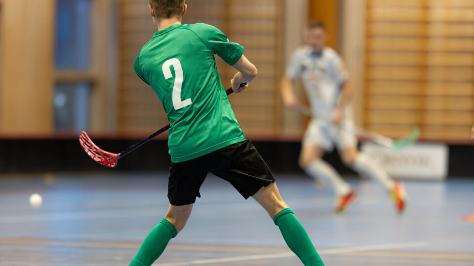 Floorball players playing in a floorball championship game